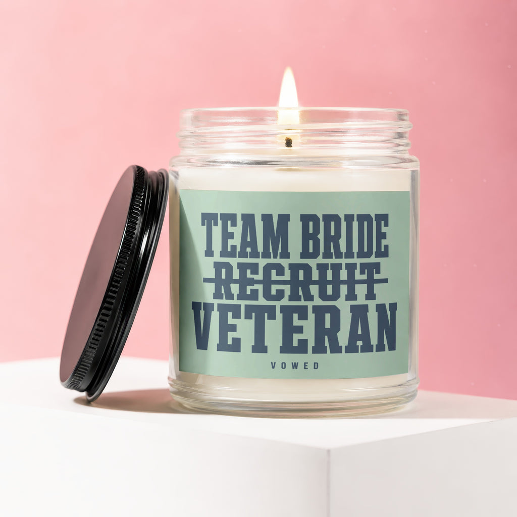 Candle with "Team Bride Recruit Veteran" and "Vowed" text on a light green label.