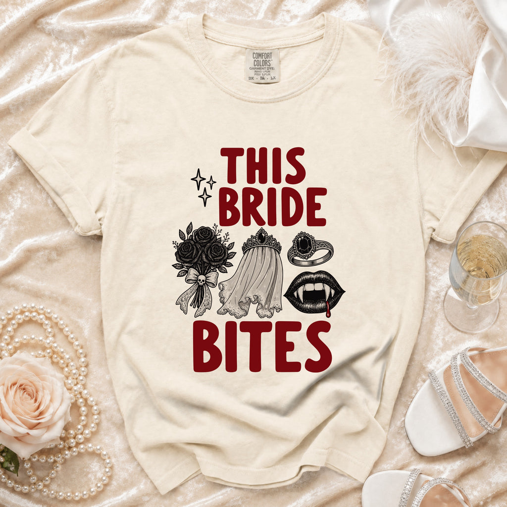 Cream t-shirt with "THIS BRIDE BITES" text and vampire-themed graphics.