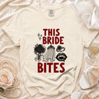 Cream t-shirt with "THIS BRIDE BITES" text and vampire-themed graphics.