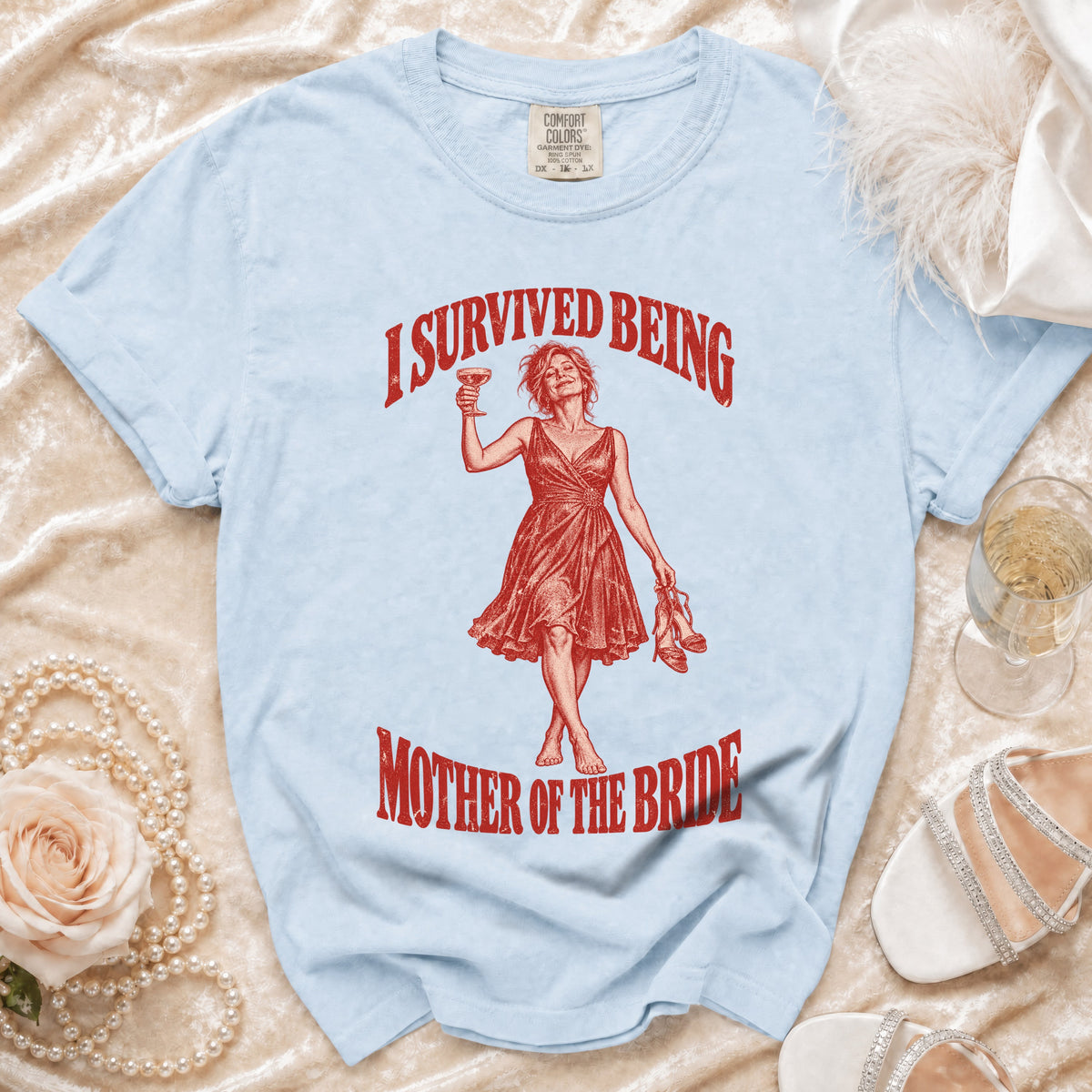 Light blue t-shirt with red graphic "I survived being mother of the bride".