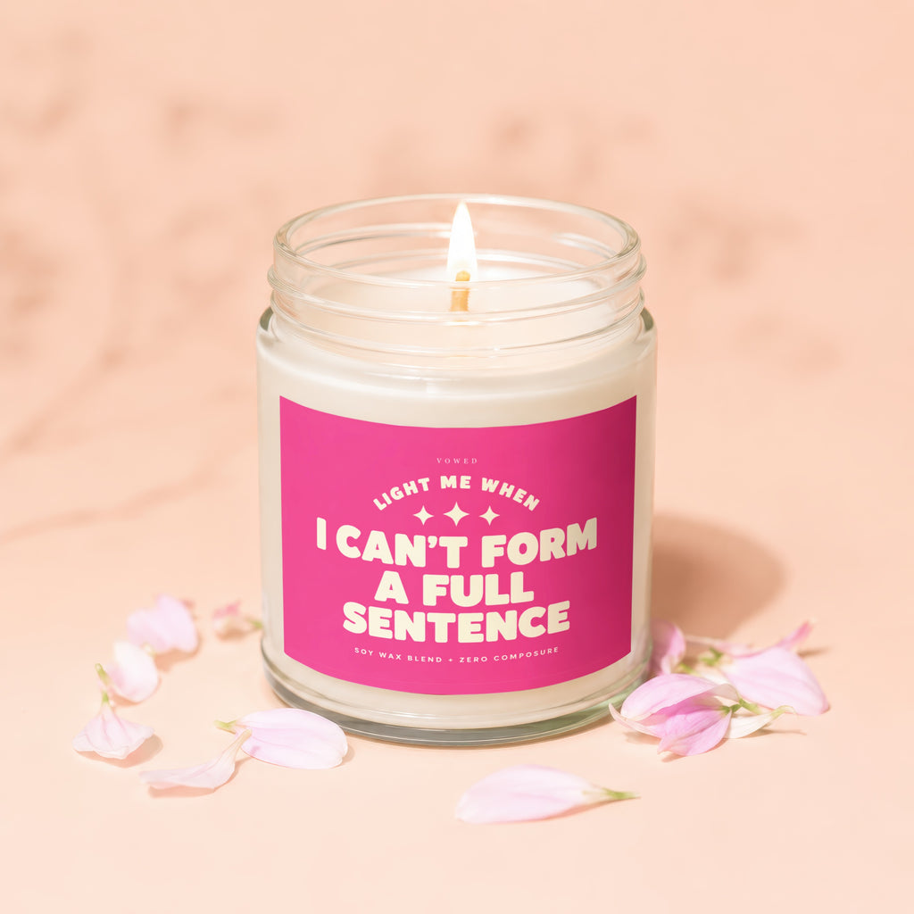 Candle with "I CAN'T FORM A FULL SENTENCE" on a pink label.