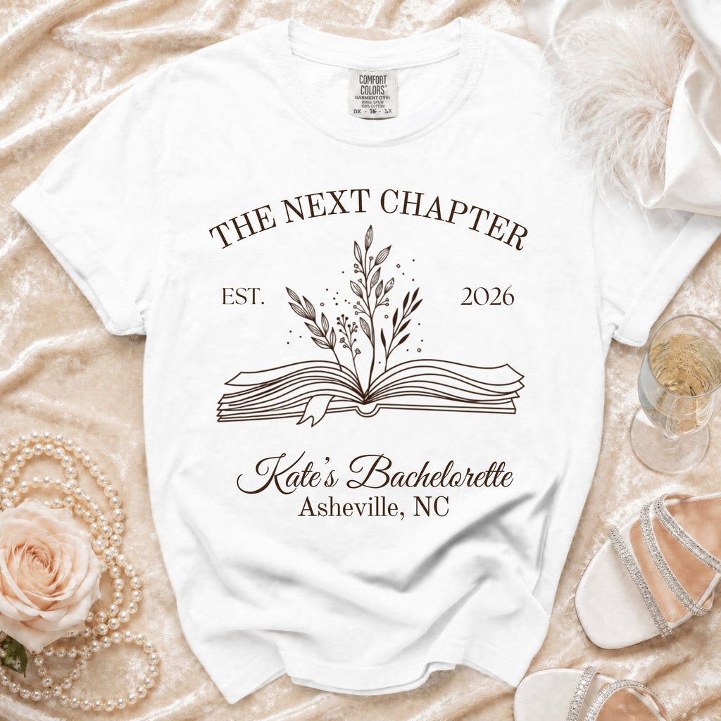 White t-shirt with "The Next Chapter Est. 2026 Kate's Bachelorette Asheville, NC".