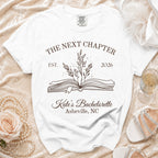 White t-shirt with "The Next Chapter Est. 2026 Kate's Bachelorette Asheville, NC".