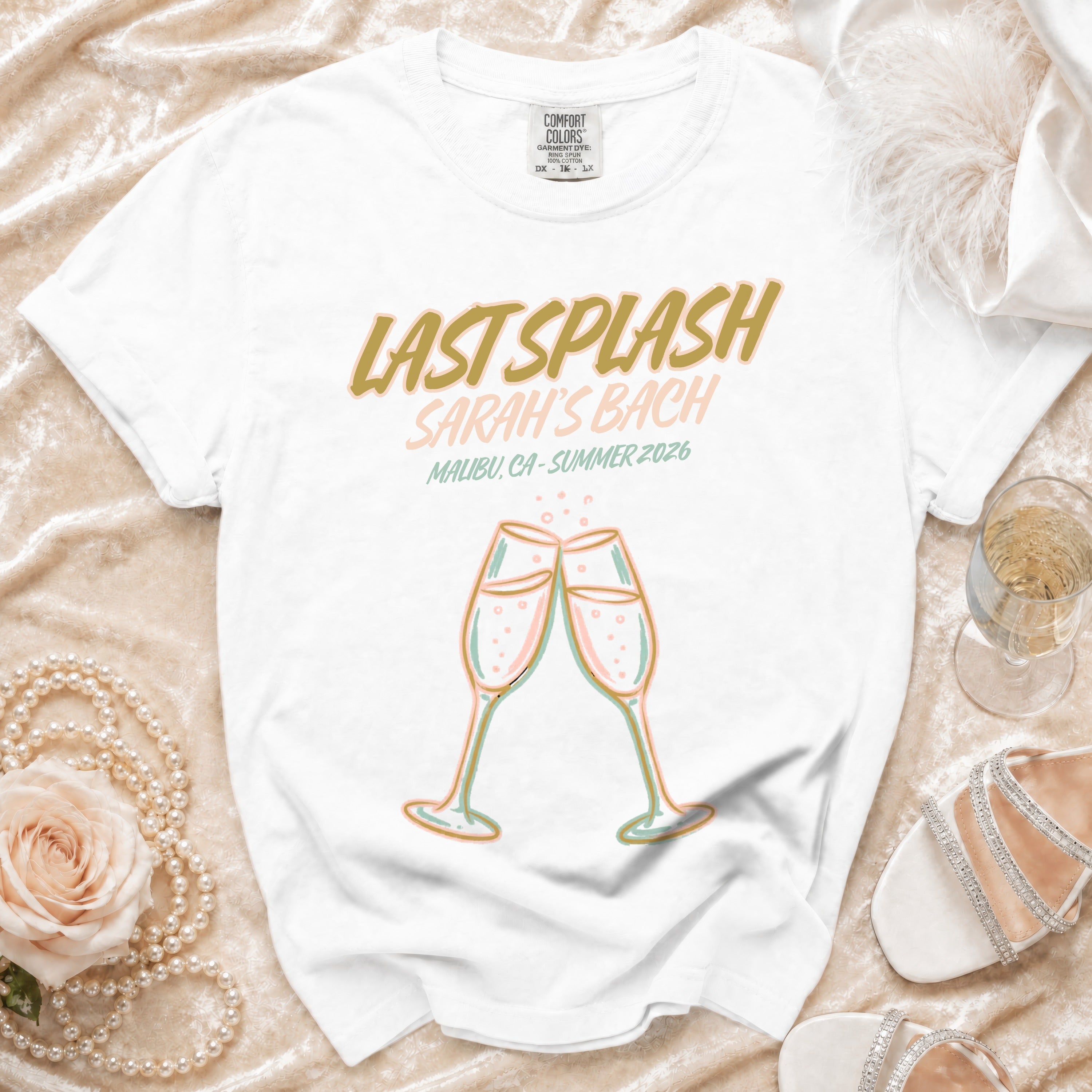 White t-shirt with "Last Splash Sarah's Bach Malibu, CA-Summer 2026" text and champagne glasses.