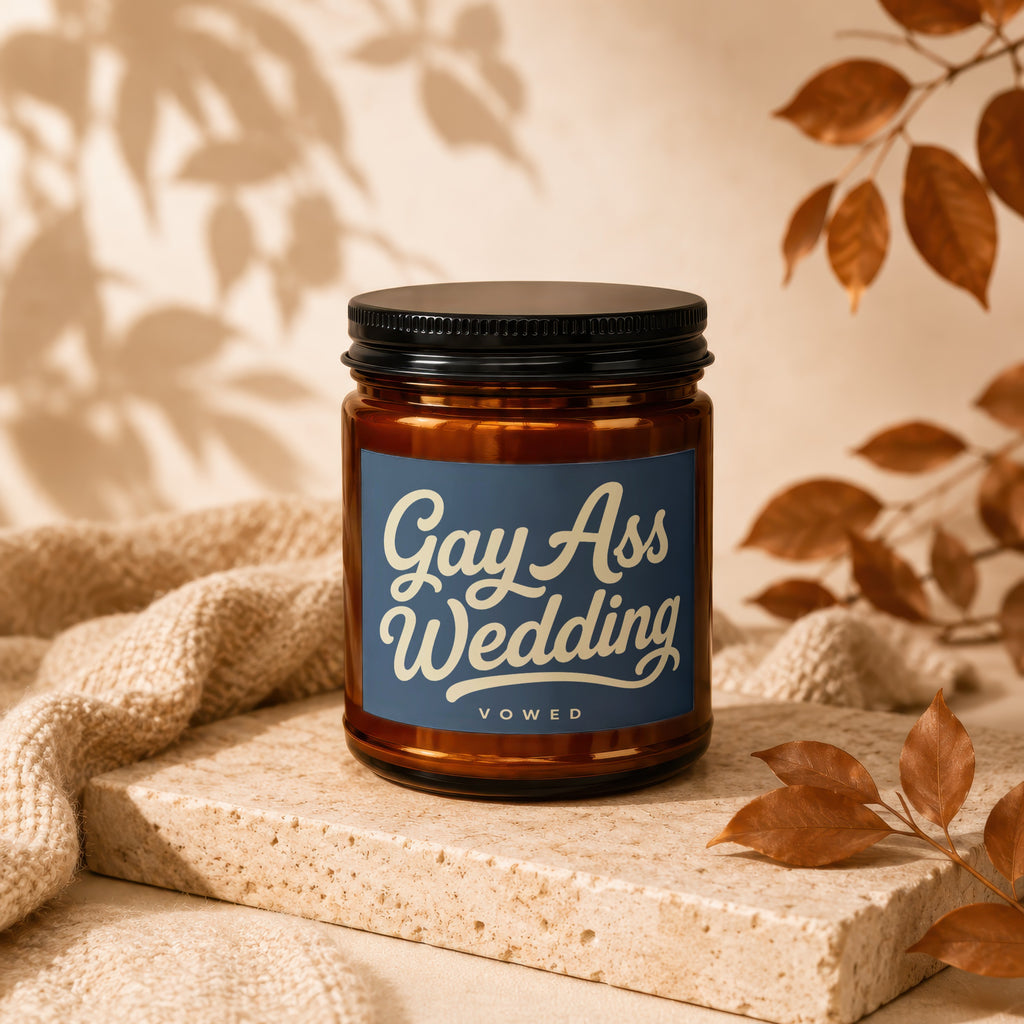 Amber jar candle with blue label reading "Gay Ass Wedding Vowed".