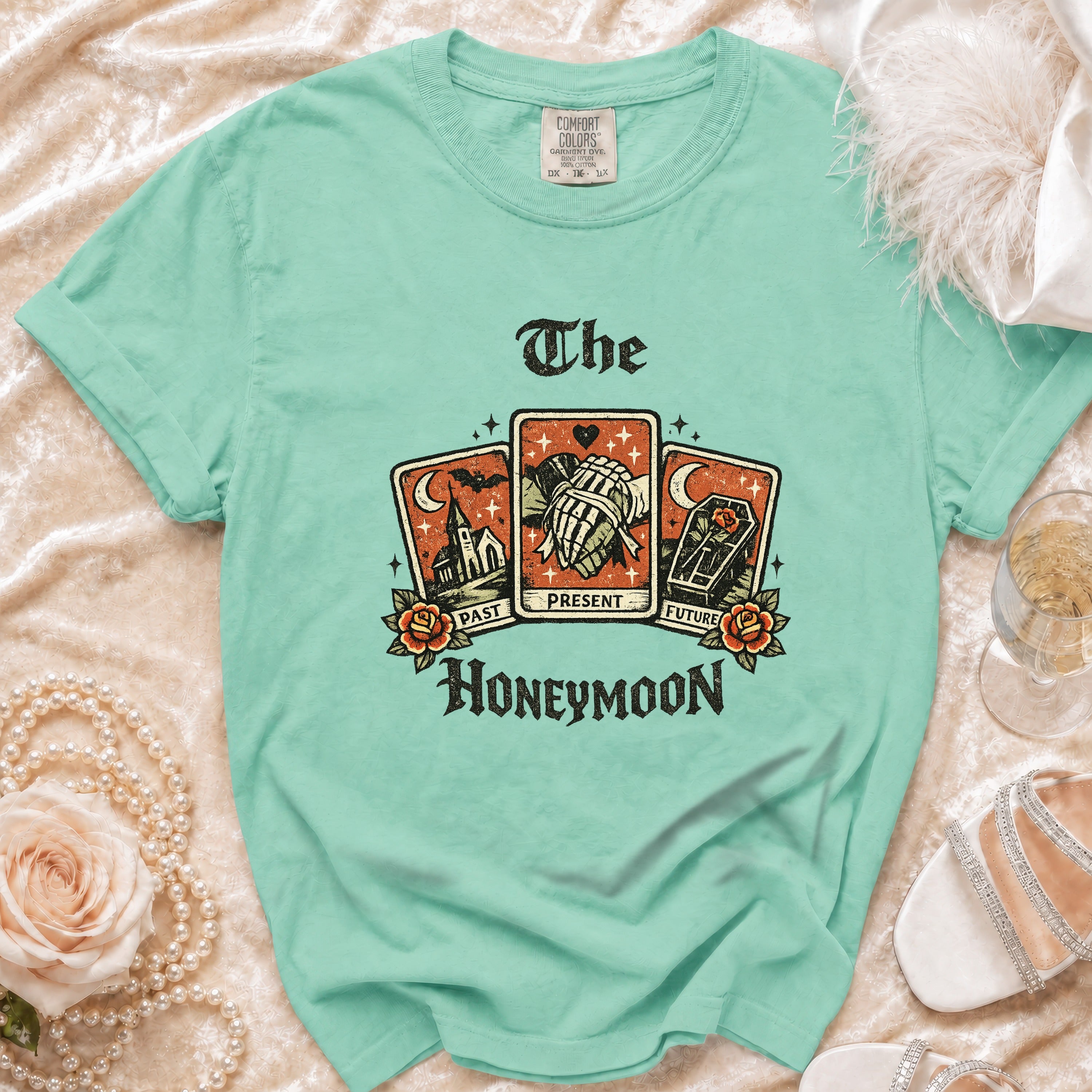 Mint green t-shirt with "The Honeymoon" tarot card graphic and Comfort Colors tag.