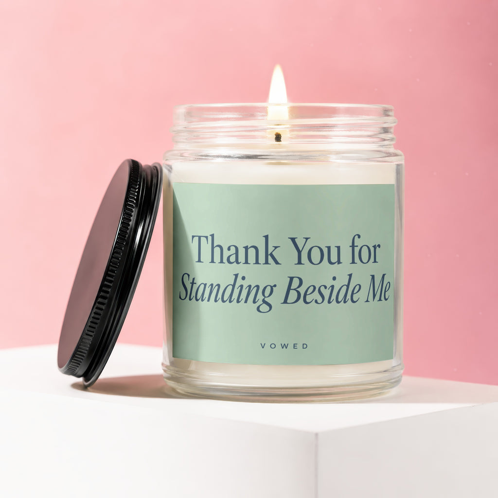 Candle with lit wick inscribed "Thank You for Standing Beside Me" and "vowed".