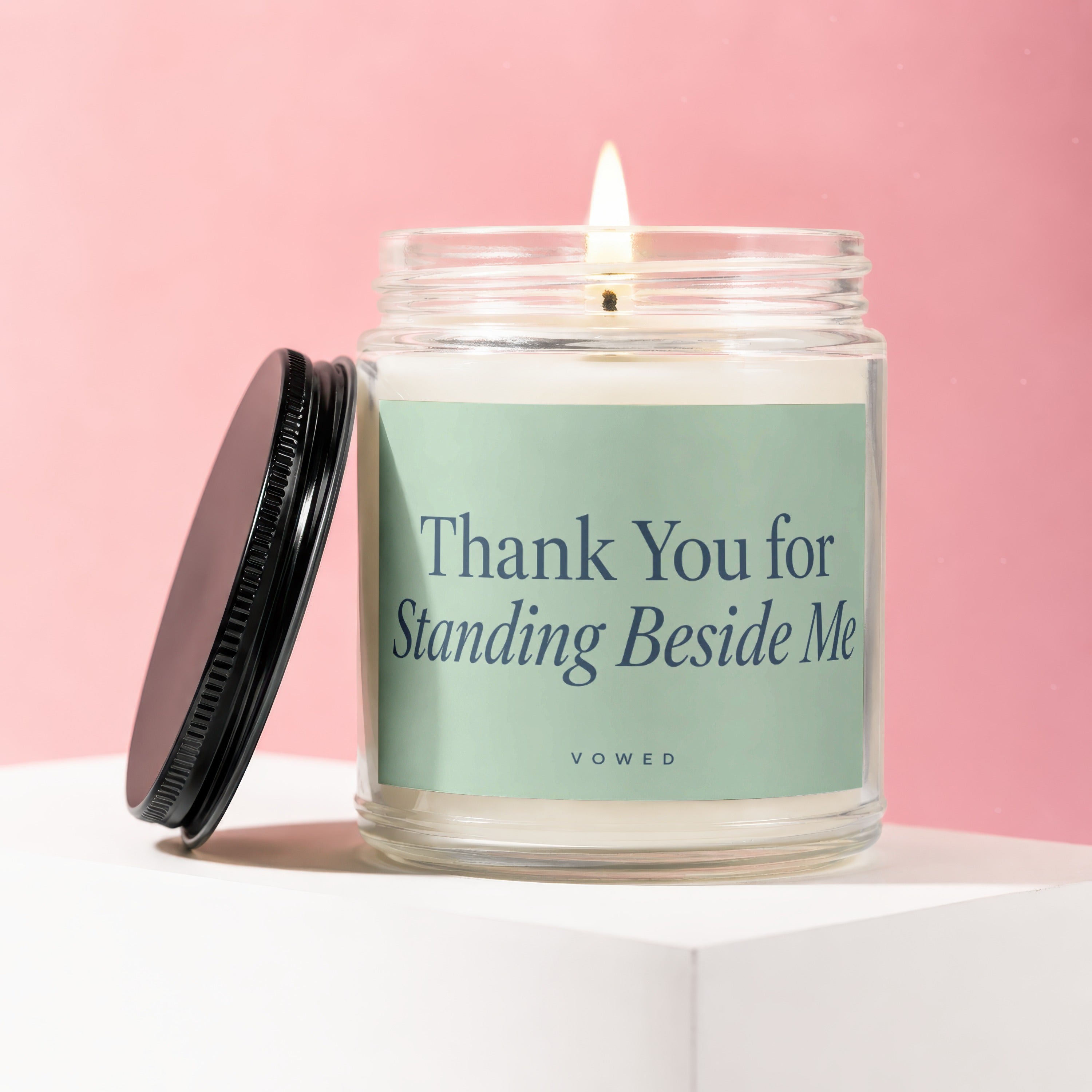 Candle with lit wick inscribed "Thank You for Standing Beside Me" and "vowed".