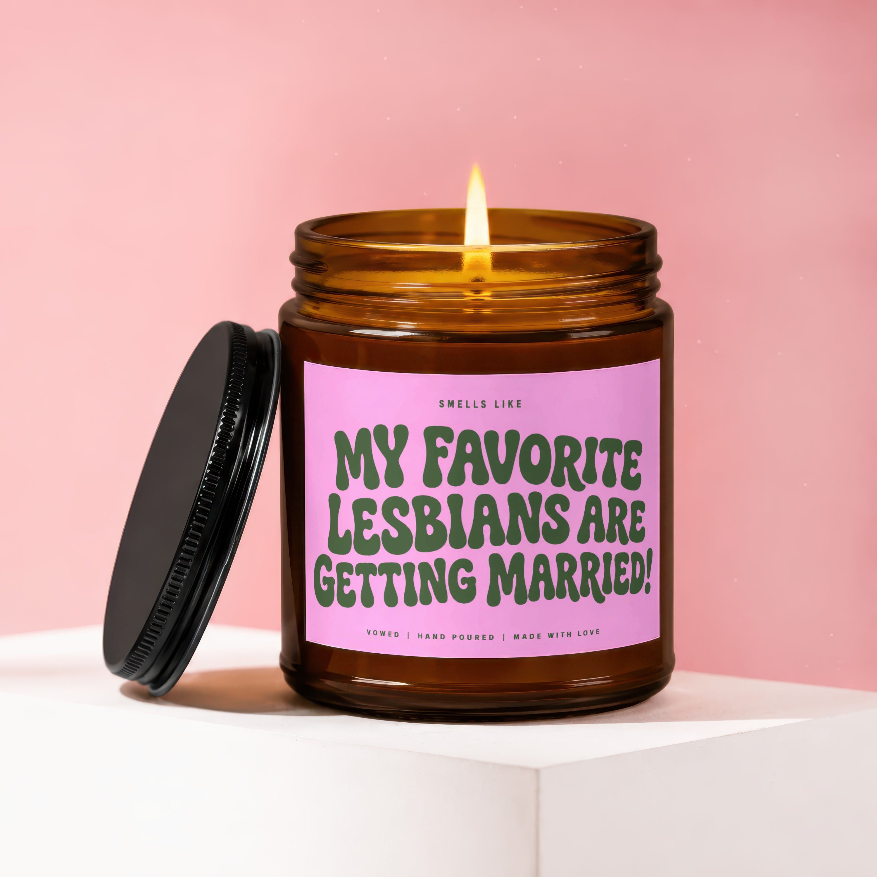 Amber candle with pink label that reads "My Favorite Lesbians Are Getting Married!".