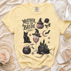 Yellow t-shirt with "Mother of the Bride (and still keeping it spooky)" Halloween graphic.