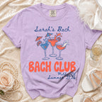 Lilac t-shirt with "Sarah's Bach" and "Bach Club Malibu, Ca Summer 2026" text.