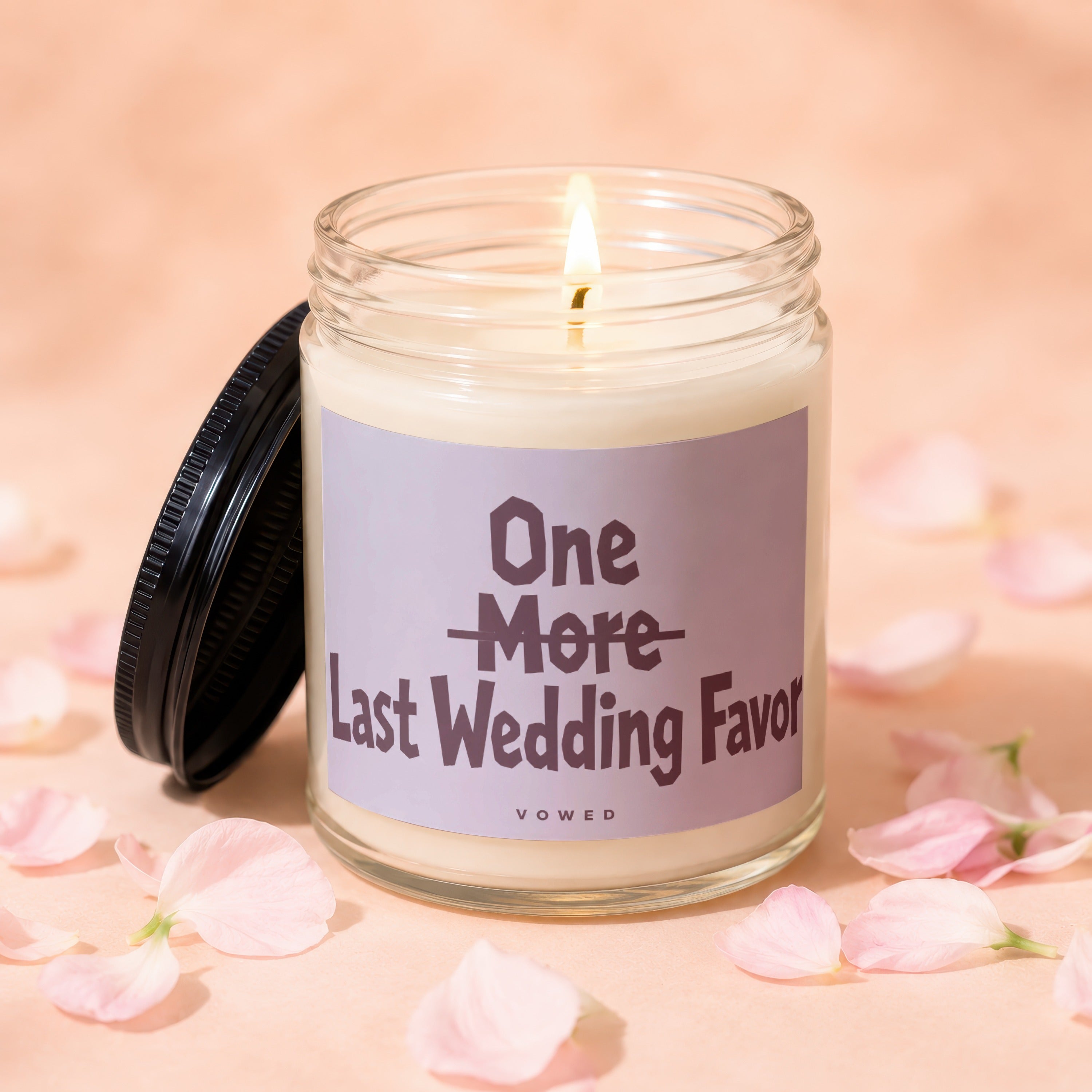 Lit candle with "One More Last Wedding Favor" text, surrounded by pink petals.