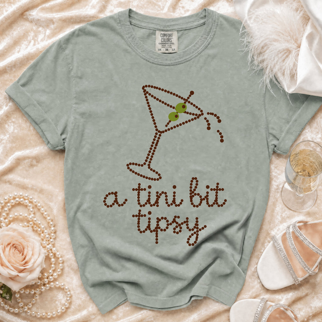 Light green t-shirt with a martini glass design and text "a tini bit tipsy".