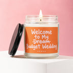 Candle with label "Welcome to My Budget Wedding" on a pink background.