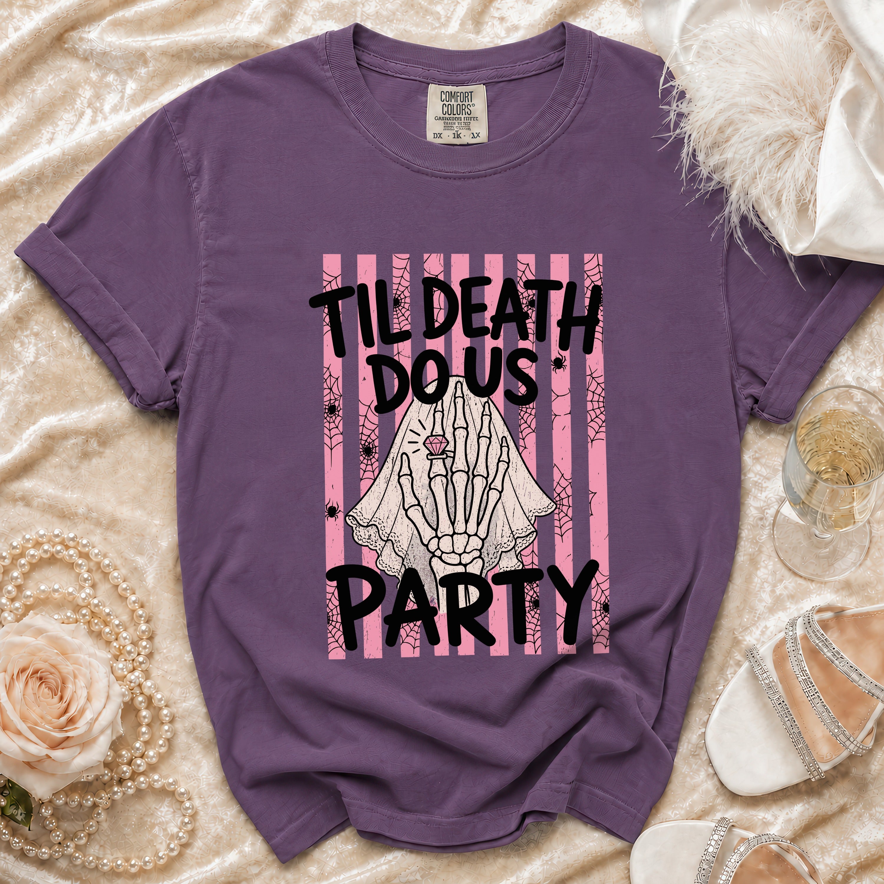Purple t-shirt with "Til Death Do Us Party" text and skeleton hand graphic.