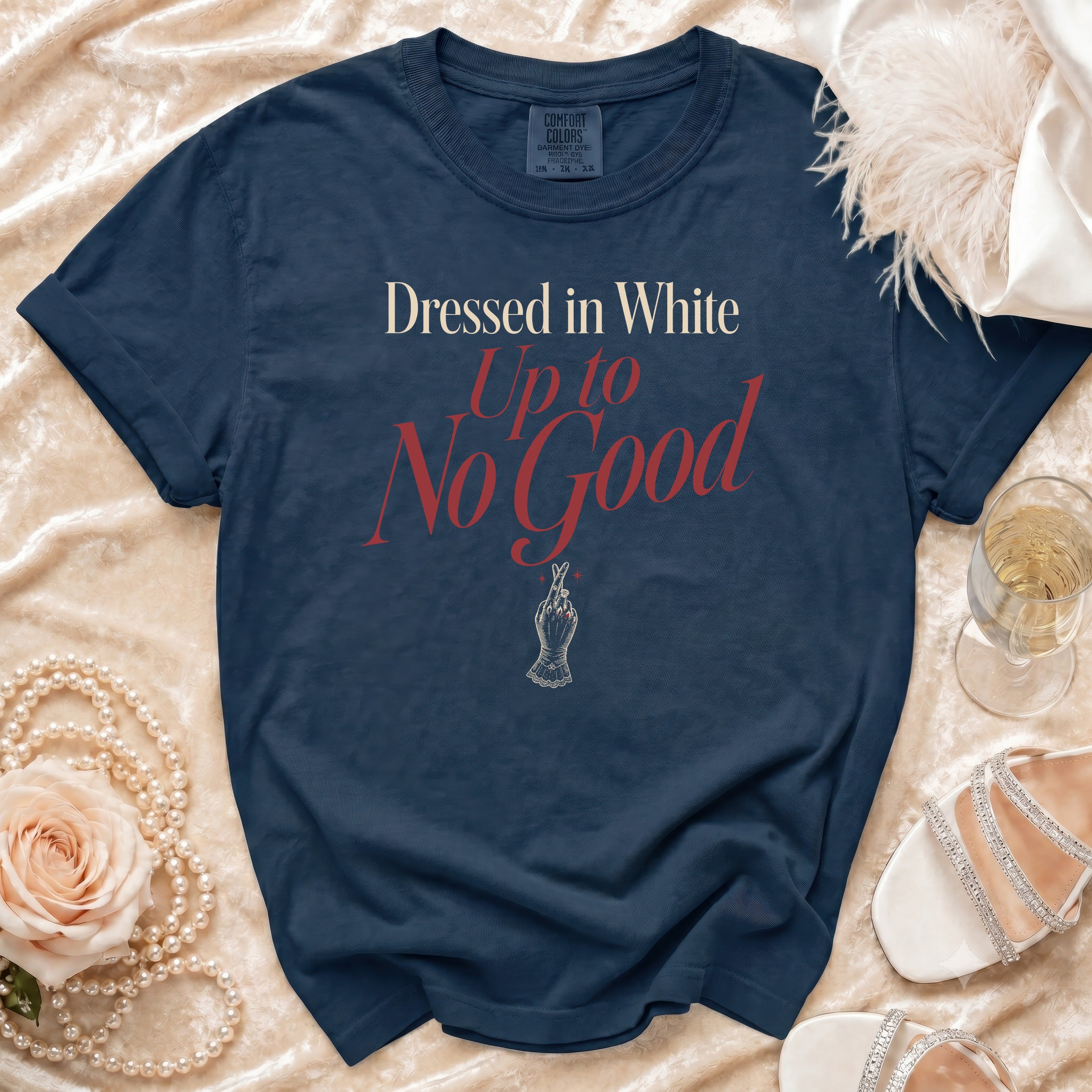 Navy Comfort Colors t-shirt with "Dressed in White Up to No Good" text.