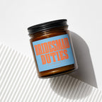 Brown glass jar with black lid and blue label reading "BRIDESMAID DUTIES (LOADING...) VOWED".