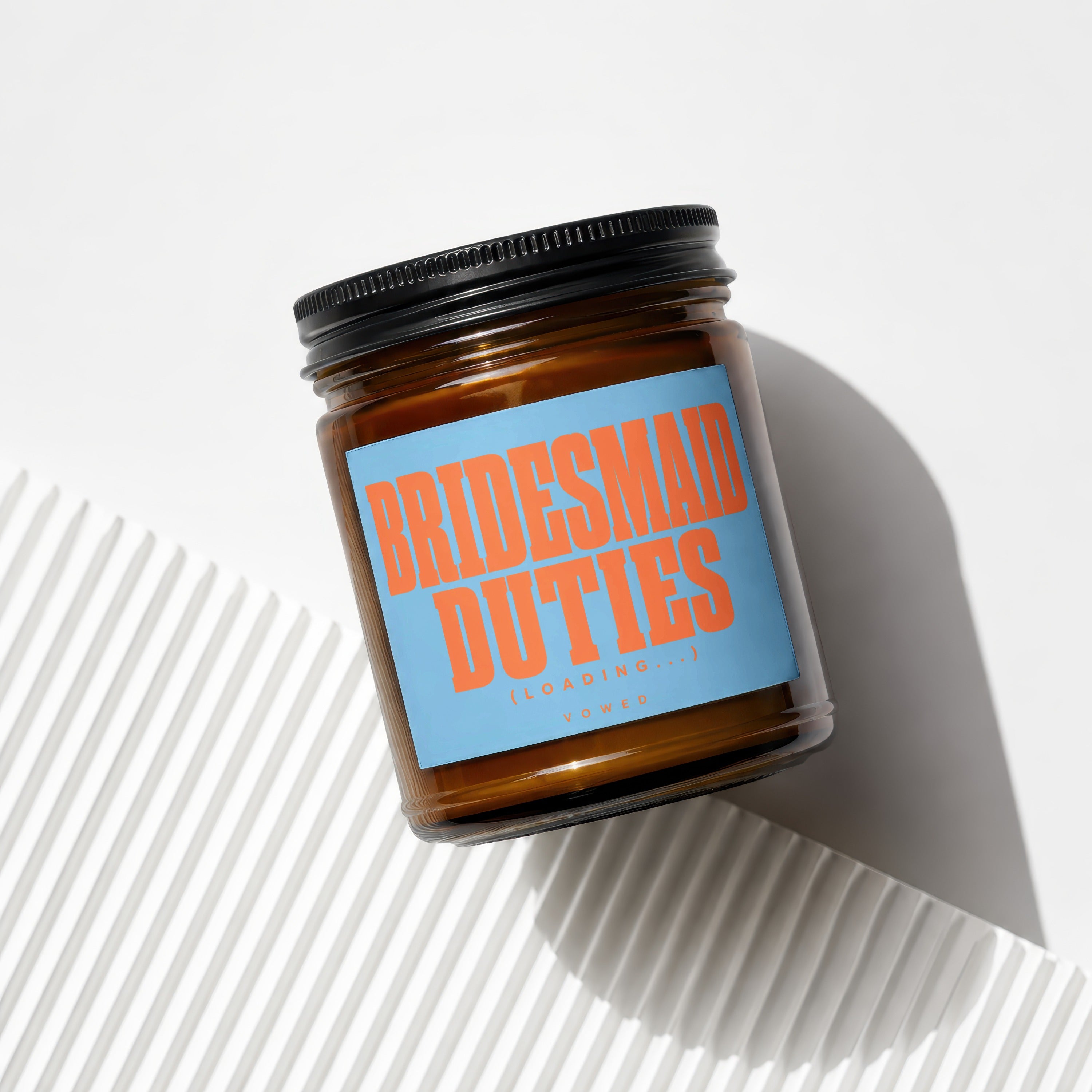 Brown glass jar with black lid and blue label reading "BRIDESMAID DUTIES (LOADING...) VOWED".