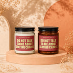 Two candles, one clear and one amber, with red labels reading "DO NOT TALK TO ME ABOUT SEATING CHARTS."