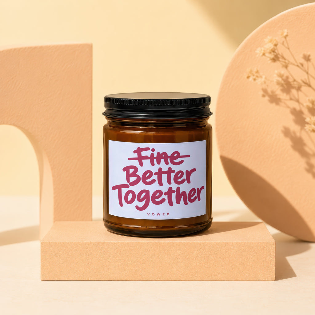 Amber glass candle with white label reading "Fine Better Together VOWED".