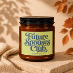 Amber jar candle with "Future Spouses Club, Vowed" text on a light green label.