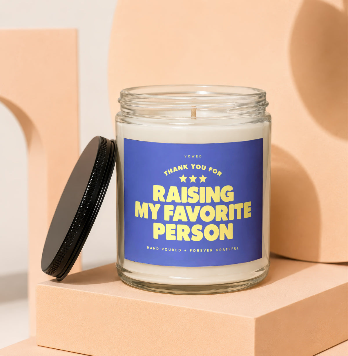 Glass candle with blue label reading "Thank You For Raising My Favorite Person".