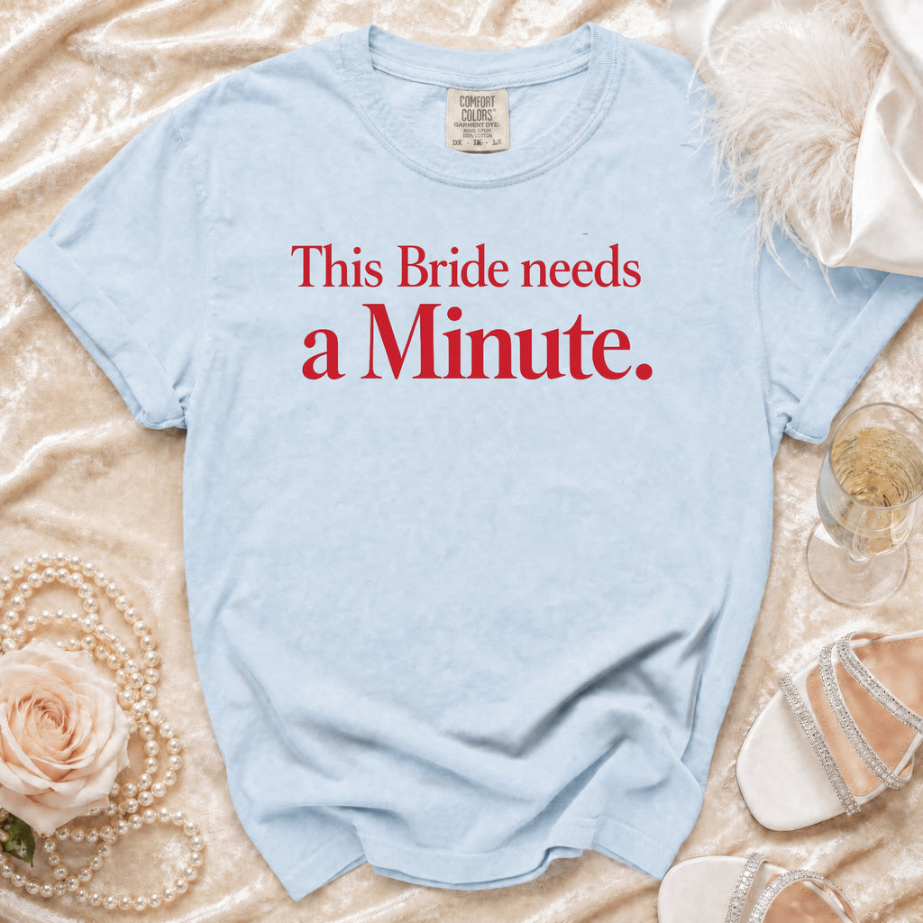 Light blue t-shirt with red text "This Bride needs a Minute."