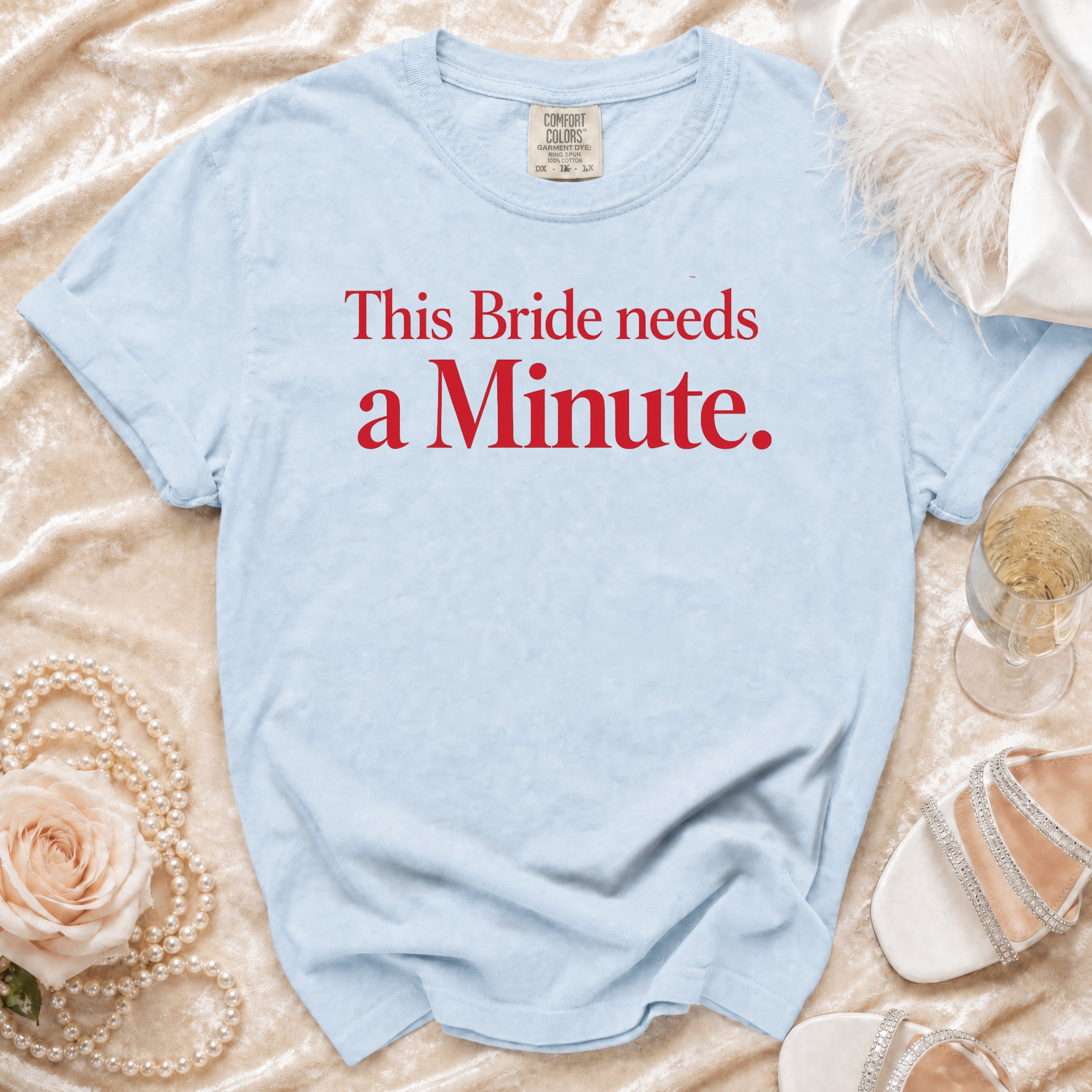 Light blue t-shirt with red text "This Bride needs a Minute."