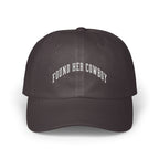A dark grey baseball cap featuring white embroidered text that reads FOUND HER COWBOY.