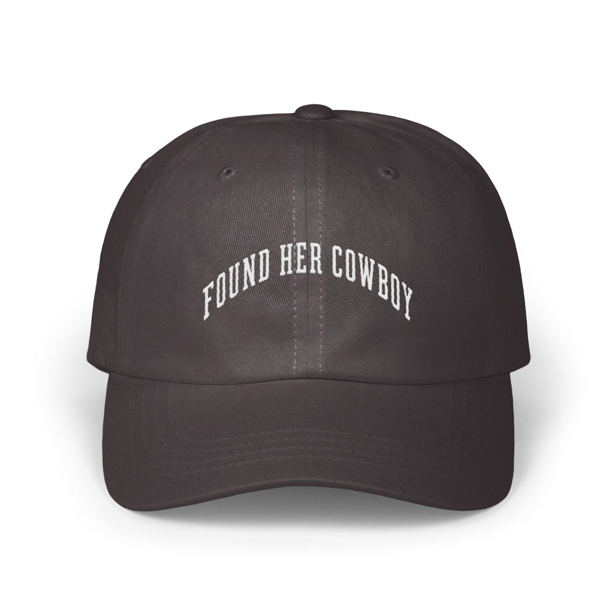 A dark grey baseball cap featuring white embroidered text that reads FOUND HER COWBOY.