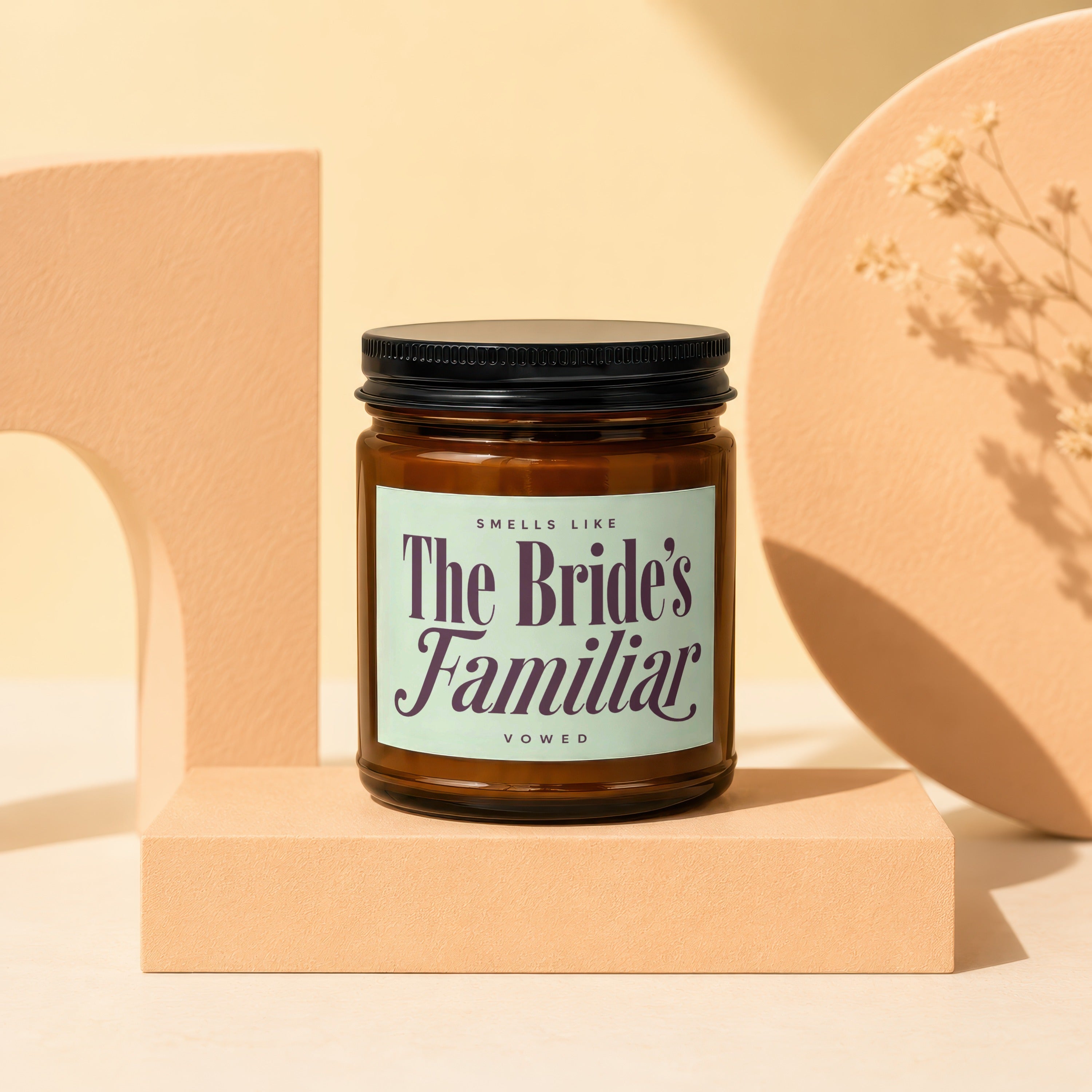 Amber glass candle with "The Bride's Familiar" label and black lid.