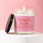 Glass candle with pink label that reads "Proudly, finally, married" and "VOWED".