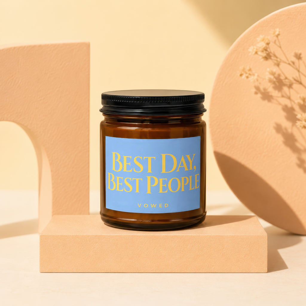 Amber candle with a blue label reading "BEST DAY, BEST PEOPLE VOWED".