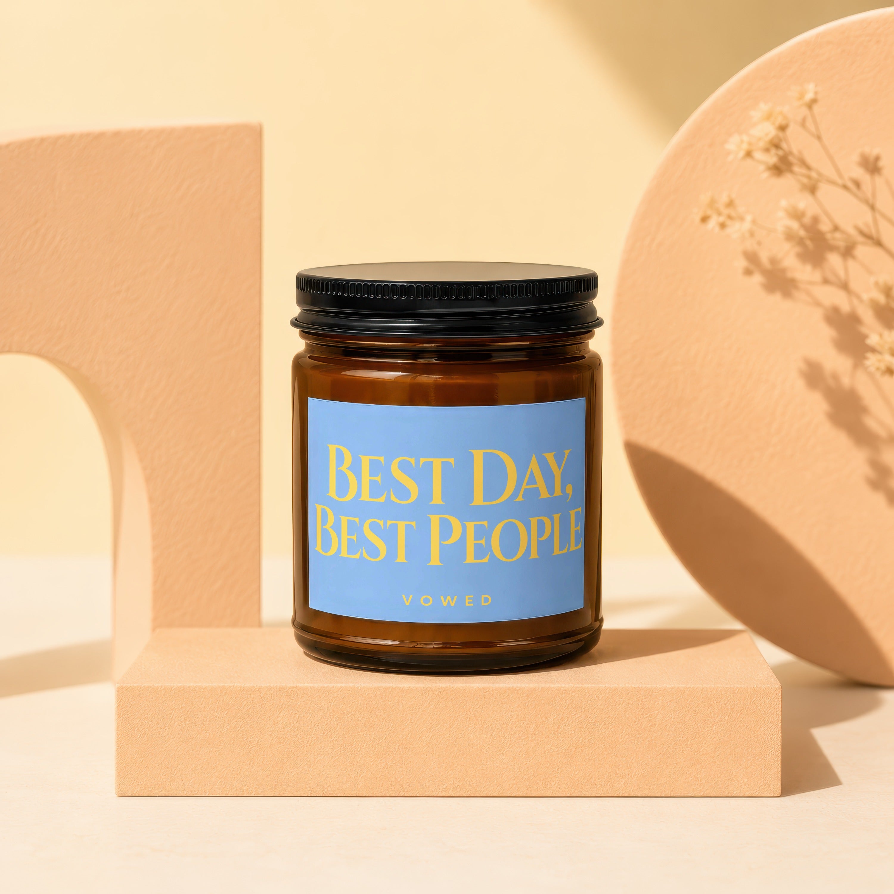 Amber candle with a blue label reading "BEST DAY, BEST PEOPLE VOWED".