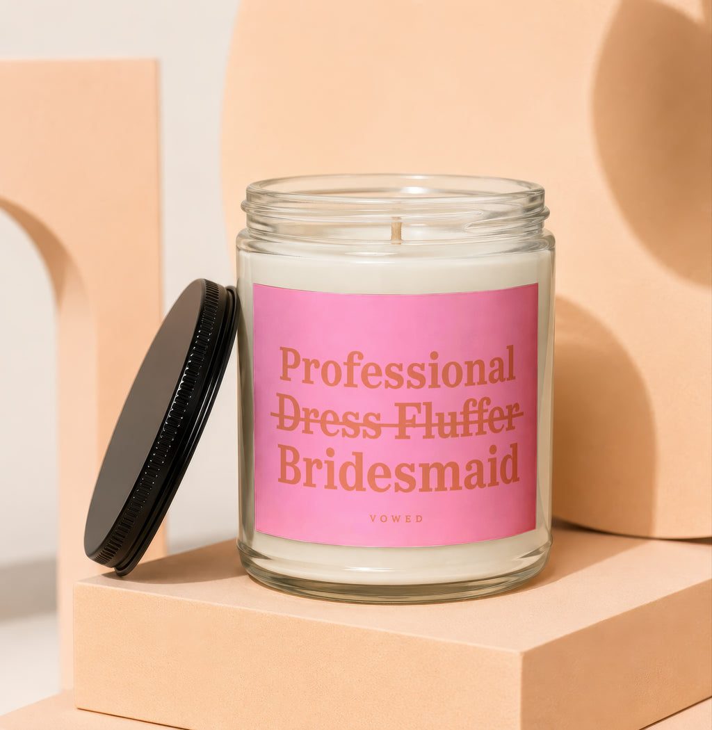 Glass candle with pink label reading "Professional Dress Fluffer Bridesmaid"