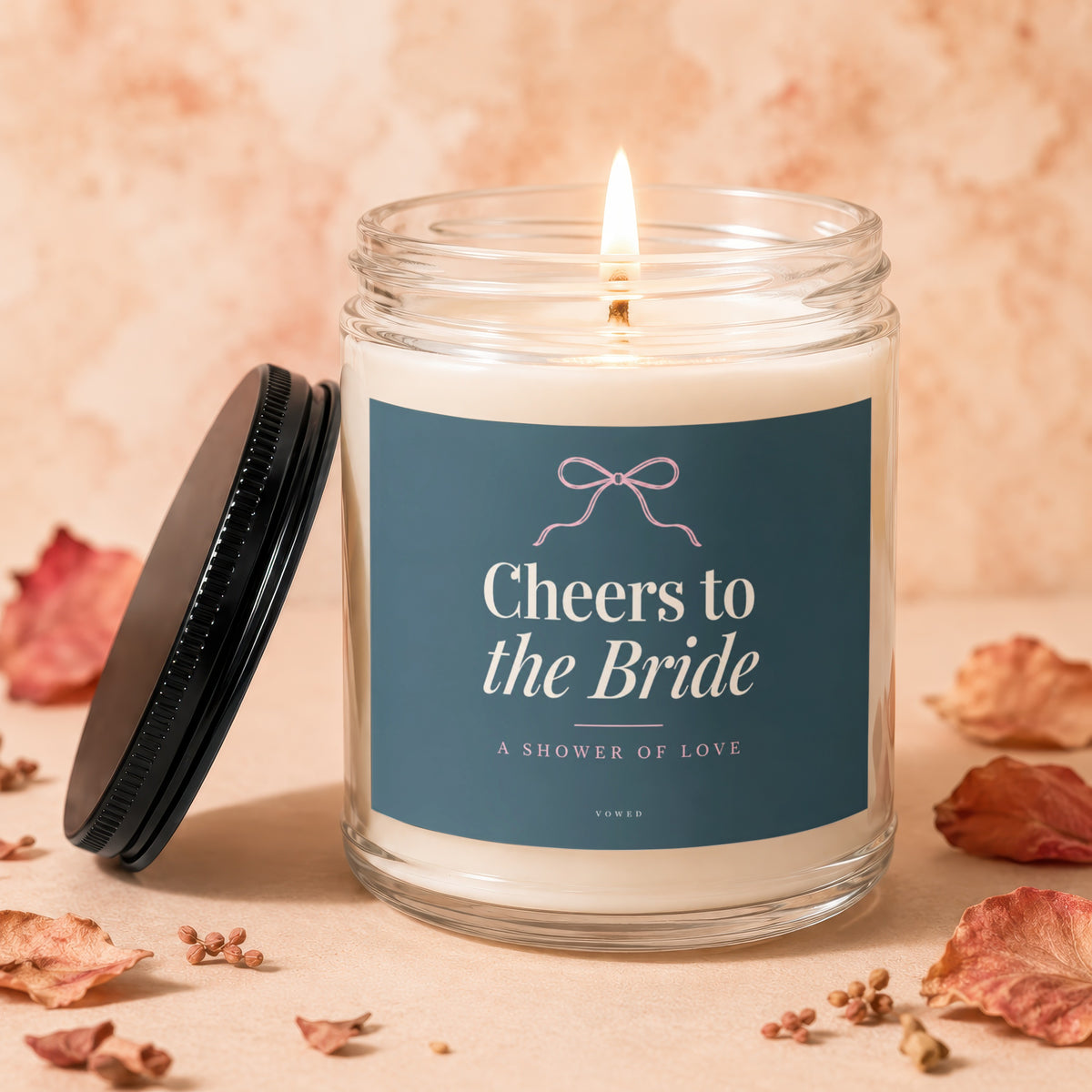 Candle with "Cheers to the Bride A Shower of Love" text on navy label.