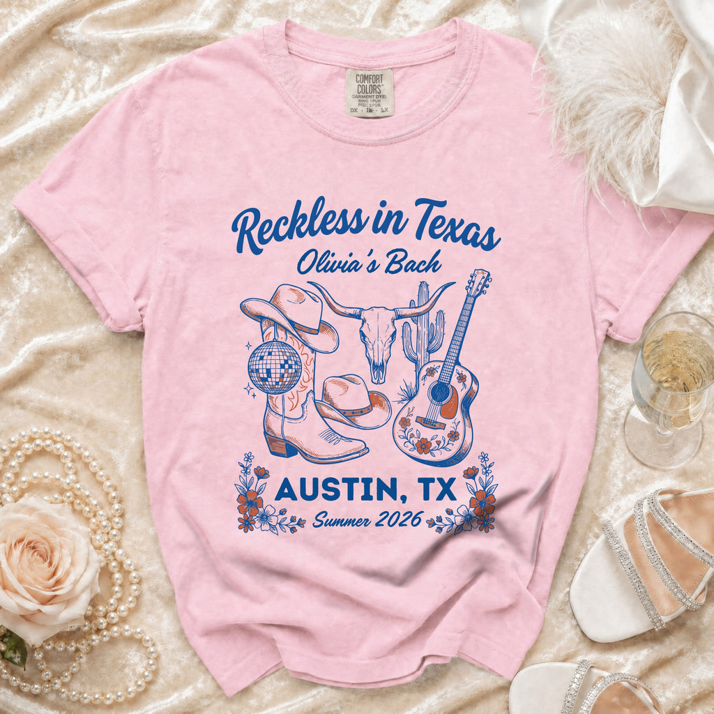 Pink t-shirt with "Reckless in Texas Olivia's Bach" and Austin, TX graphic.