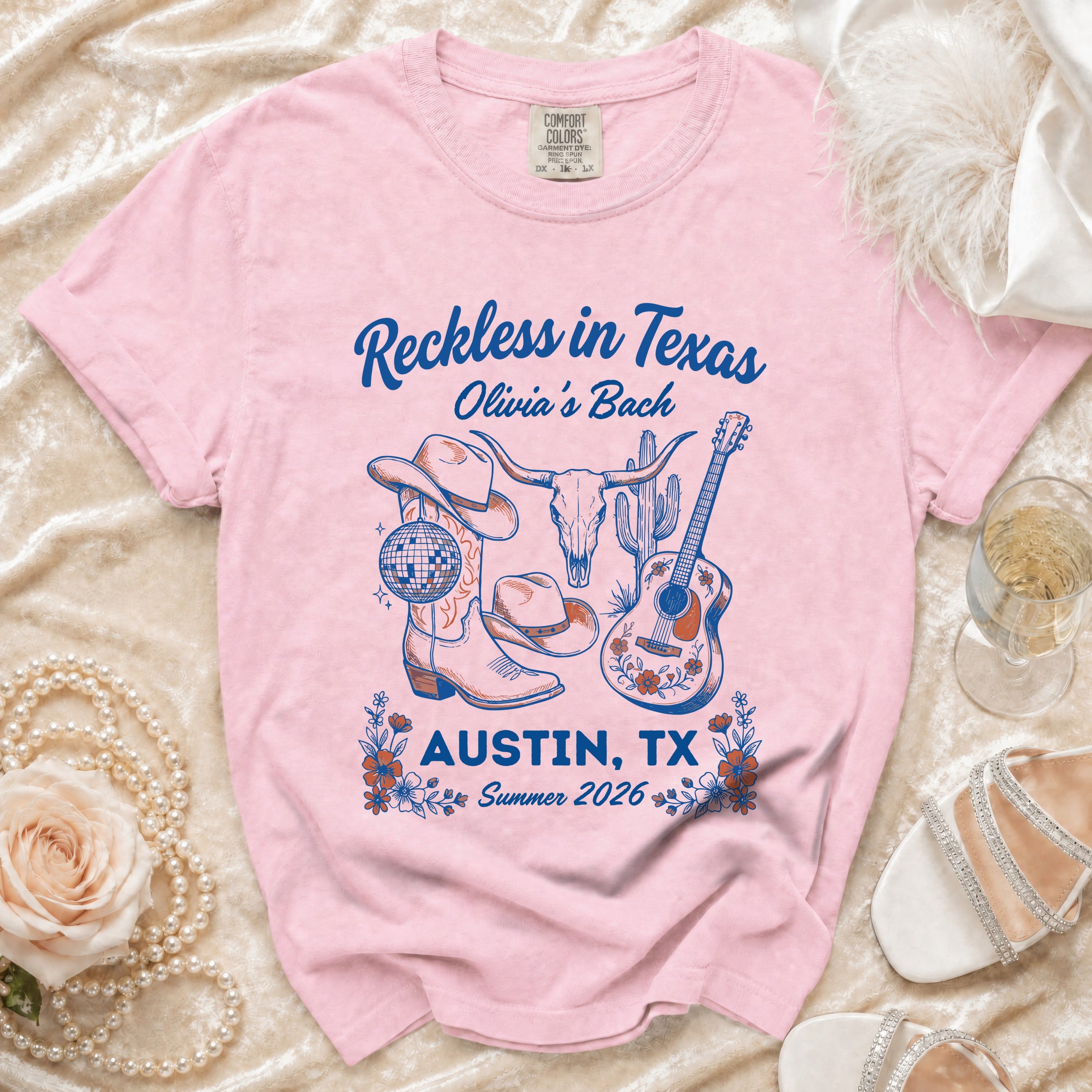 Pink t-shirt with "Reckless in Texas Olivia's Bach" and Austin, TX graphic.