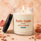 Candle with "Ruth + Caleb still no refunds" text, lit flame, and black lid.