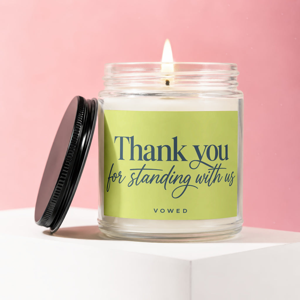 Candle with "Thank you for standing with us vowed" text on a pastel pink background.