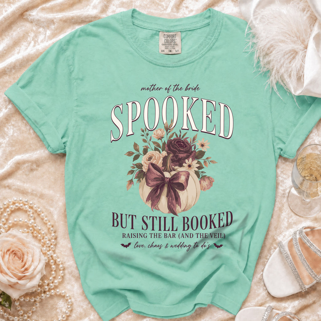 Mint green t-shirt: "Mother of the Bride Spooked But Still Booked" graphic.