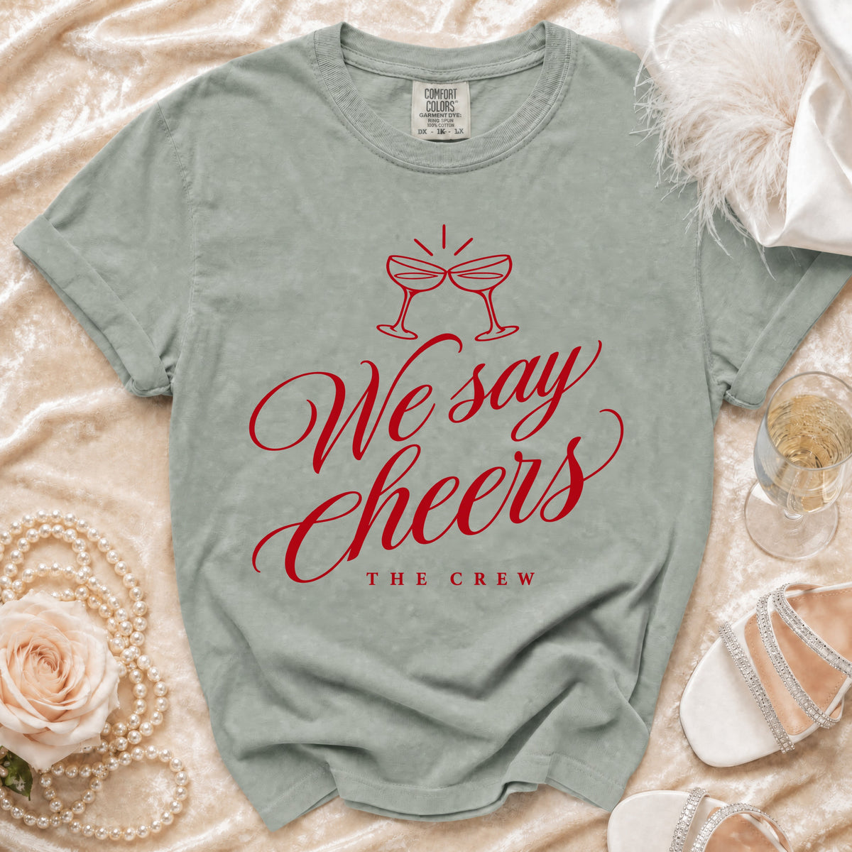 Light sage t-shirt with red text "We say Cheers The Crew".