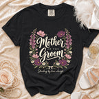 Black t-shirt with floral wreath and text "Mother of the Groom Standing by him, always".