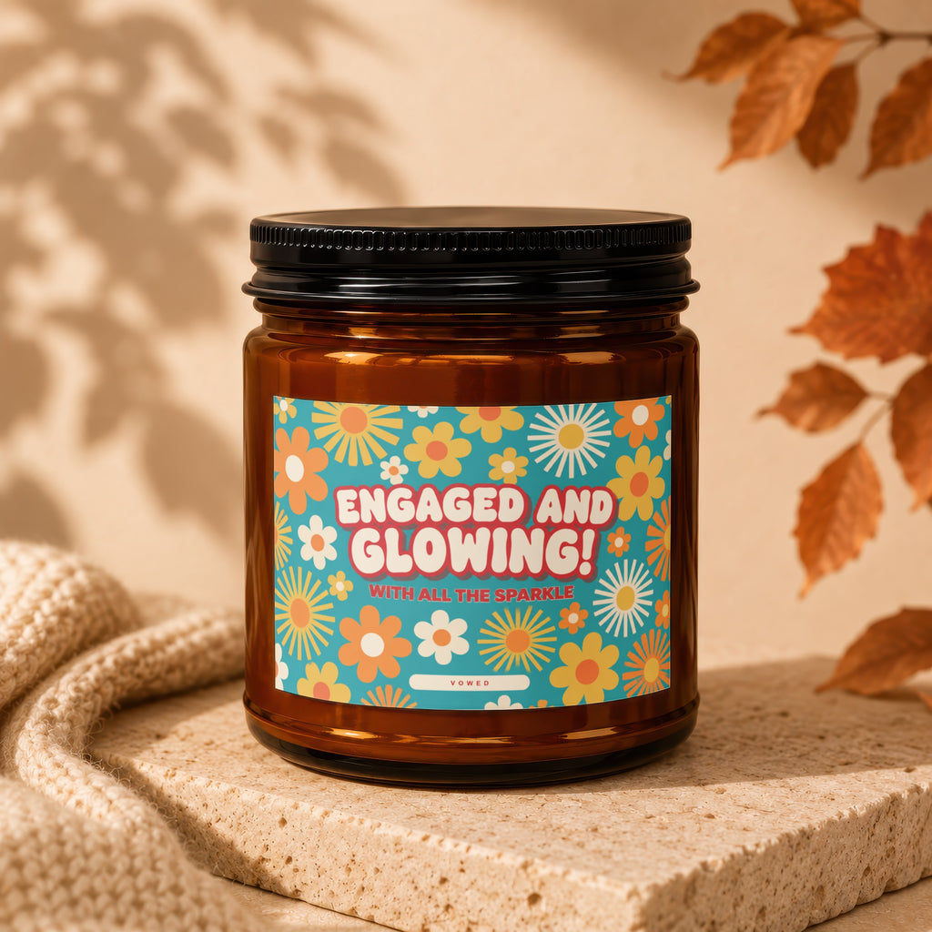 Brown glass candle with "Engaged and Glowing!" text and floral pattern label.