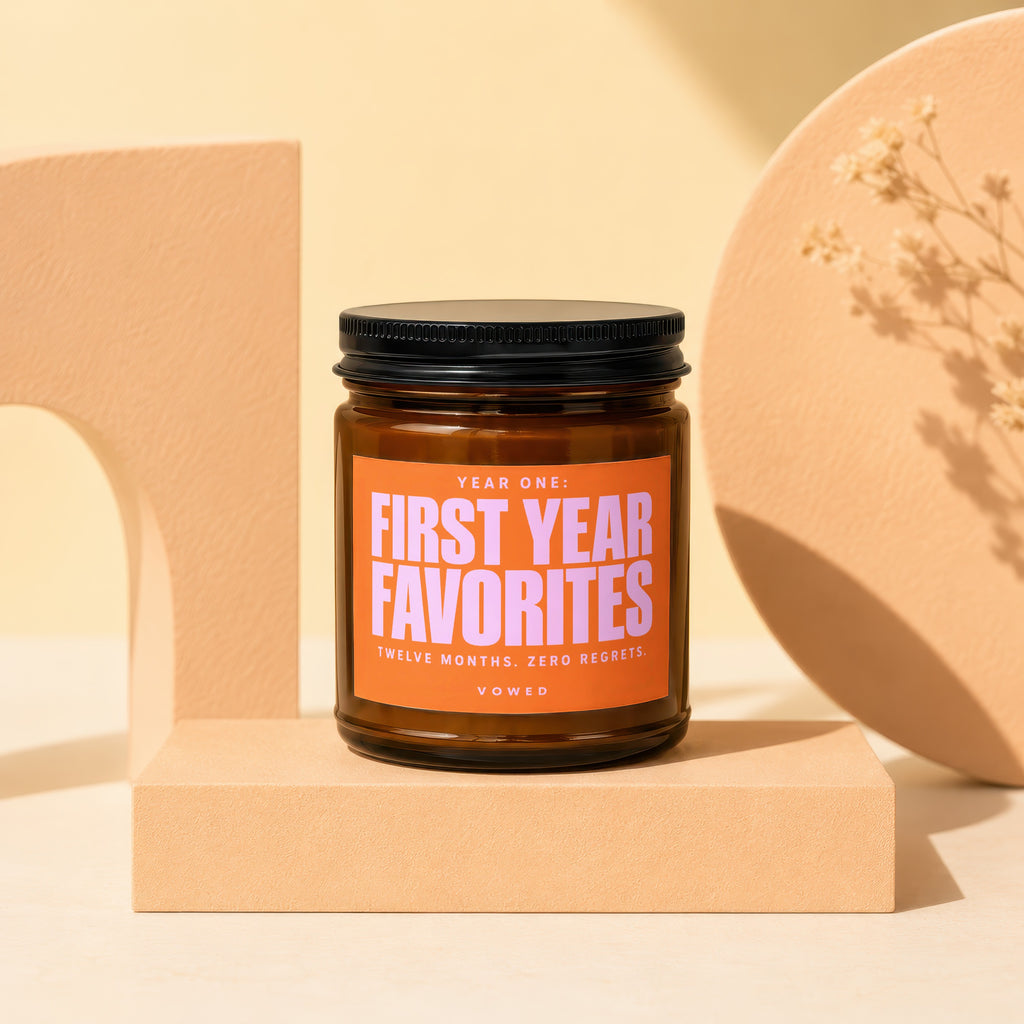 Amber jar candle labeled "Year One: First Year Favorites Twelve Months. Zero Regrets. Vowed."