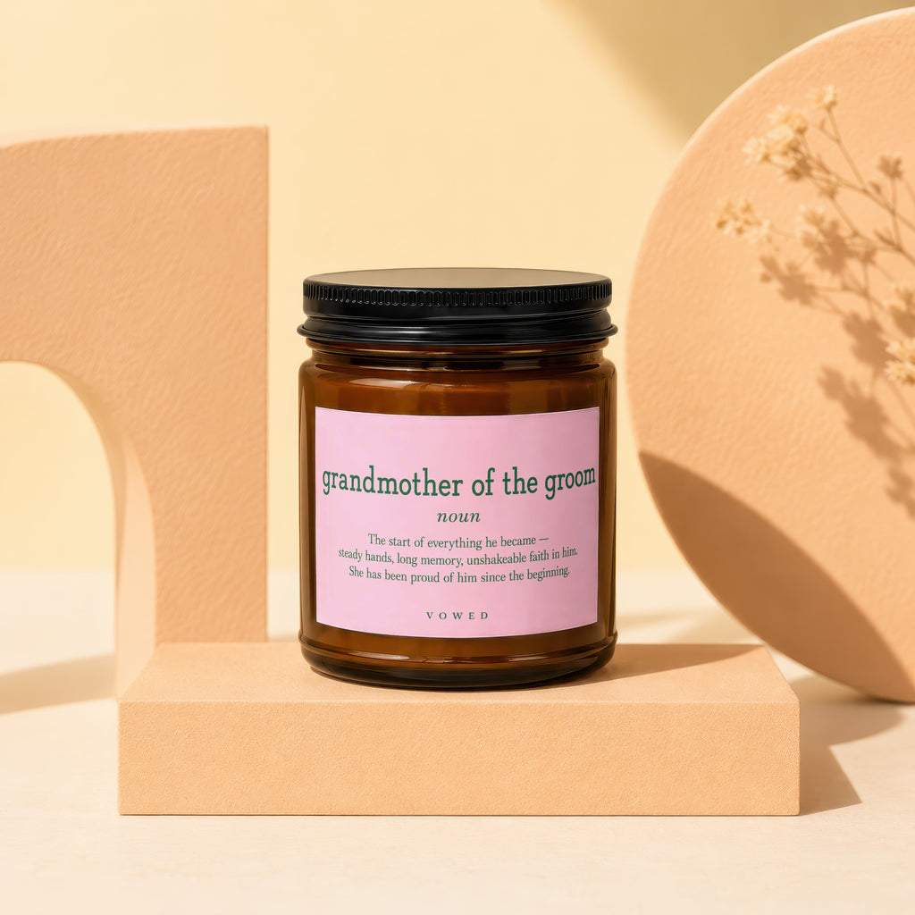 Glass candle with pink label for "grandmother of the groom" definition.