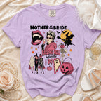 Purple t-shirt with "Mother of the Bride Raising Hell Before I Do" and Halloween graphics.