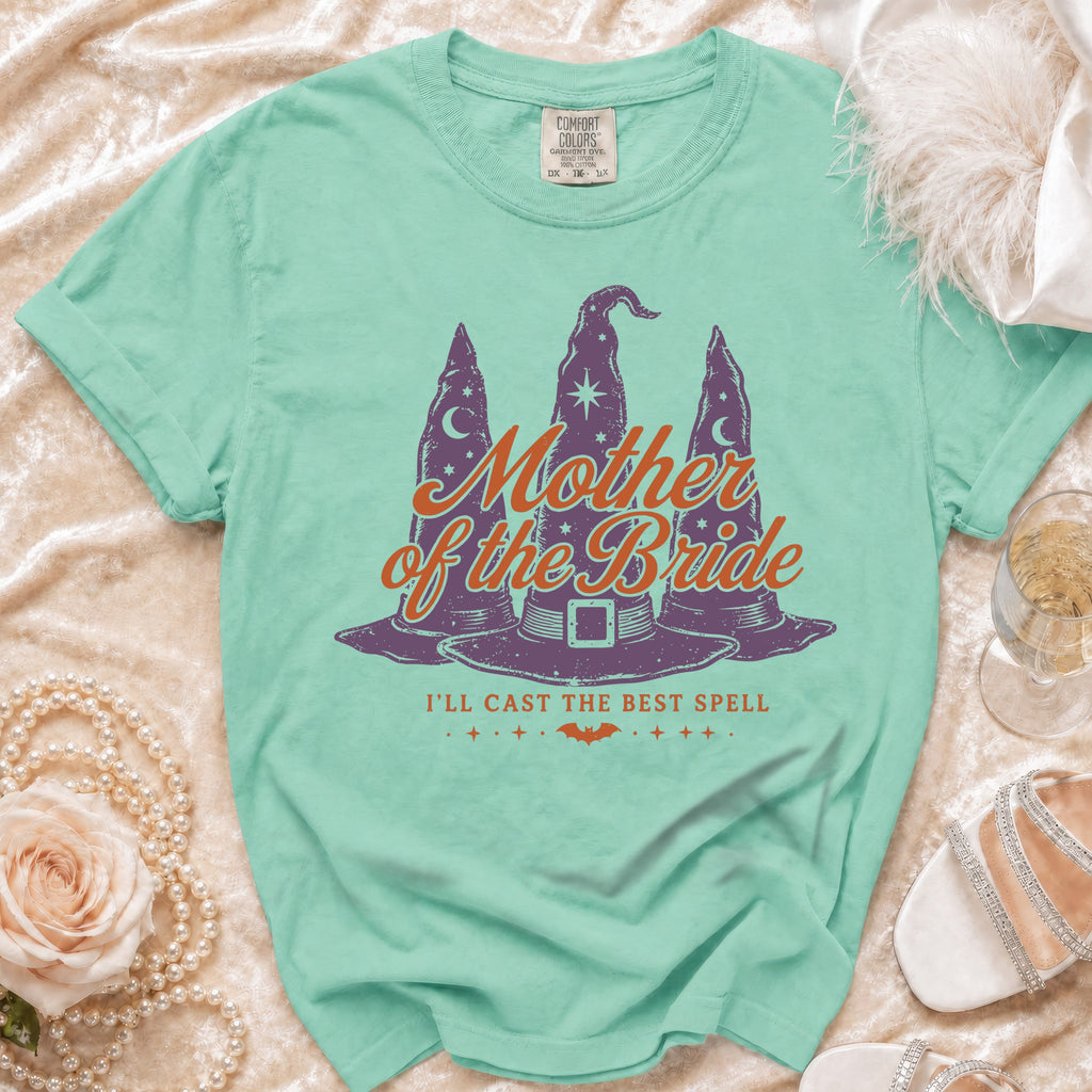 Mint green t-shirt with "Mother of the Bride I'll Cast the Best Spell" graphic.
