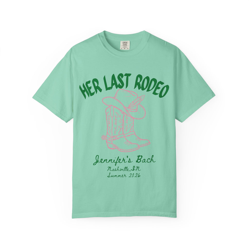Green t-shirt with pink text "Her Last Rodeo" and cowboy boot graphic.