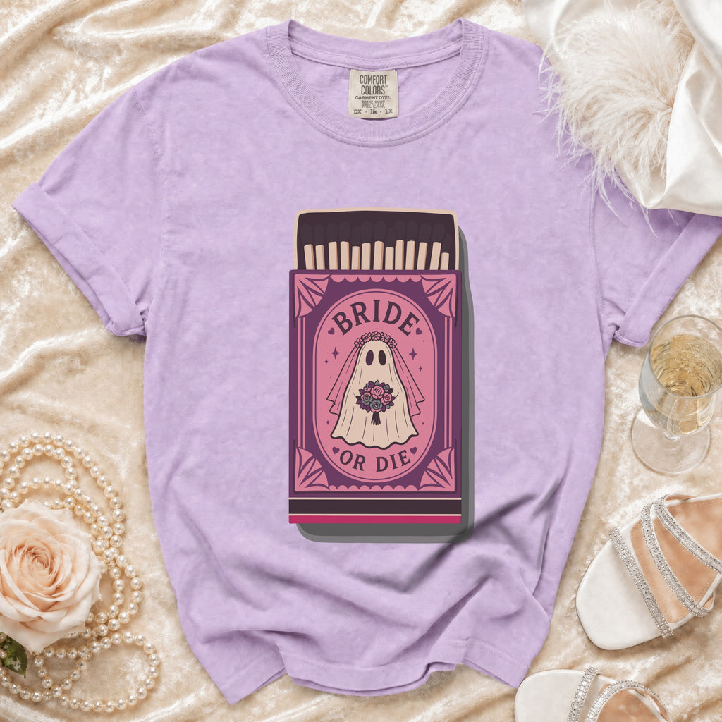 Lilac t-shirt with a "Bride or Die" ghost graphic in a matchbox design.